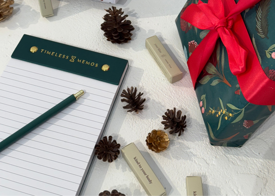 Gift-wrapped presents with ribbons on a surface with decorative items.